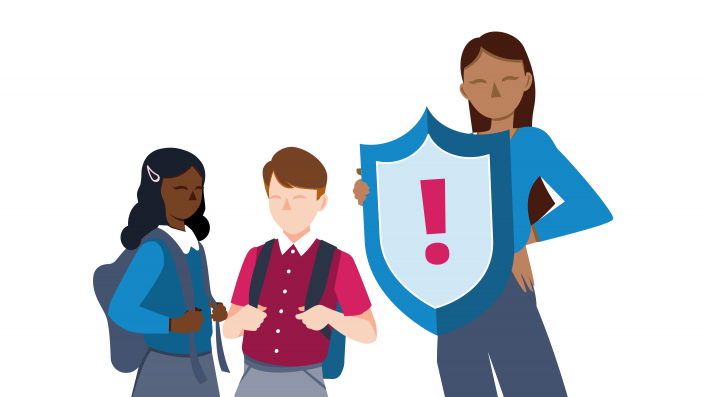 Teacher holding a safeguarding shield in front of their students